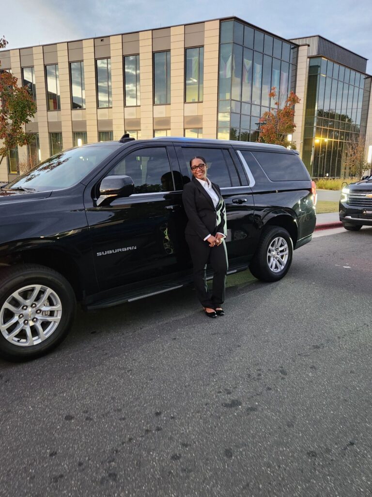 LaShonda, standing beside a car